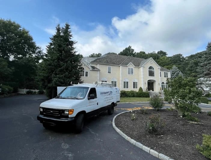 Willowick Power Washing technician performing thorough gutter cleaning service in Willowick